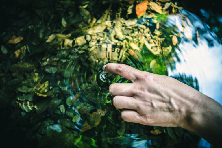 close-up-hand-touching-water